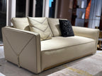 Luxury Cream Leather Sofa with Decorative Pillows and Gold Accents