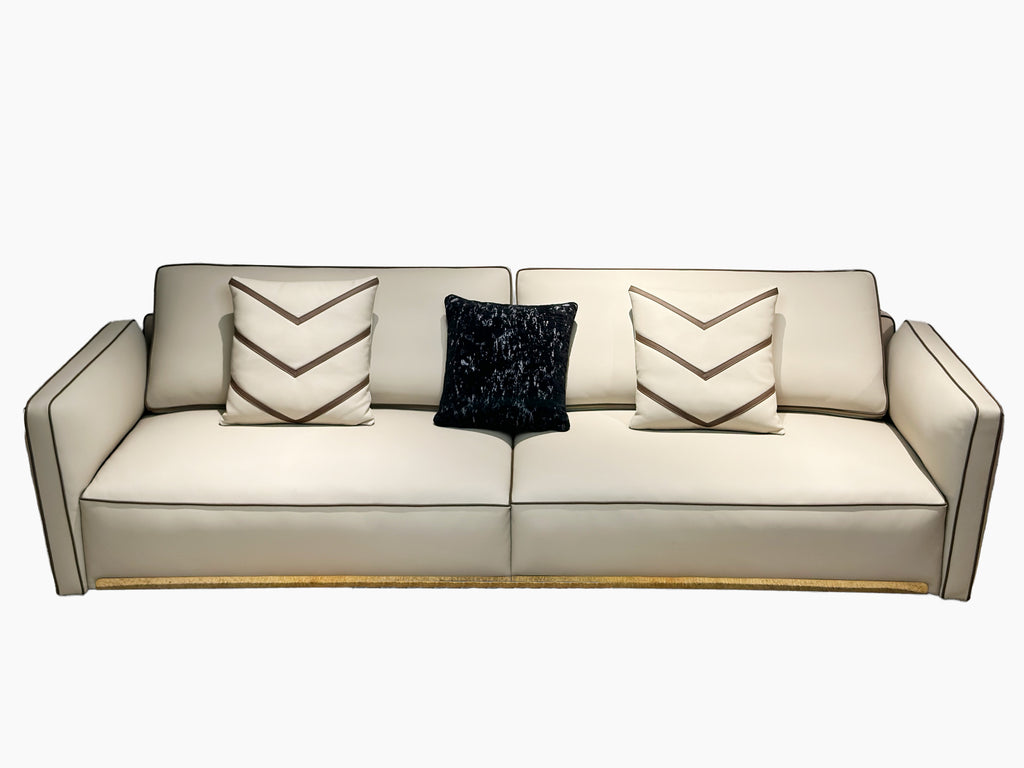 Luxury Cream Leather Sofa with Decorative Pillows and Gold Accents