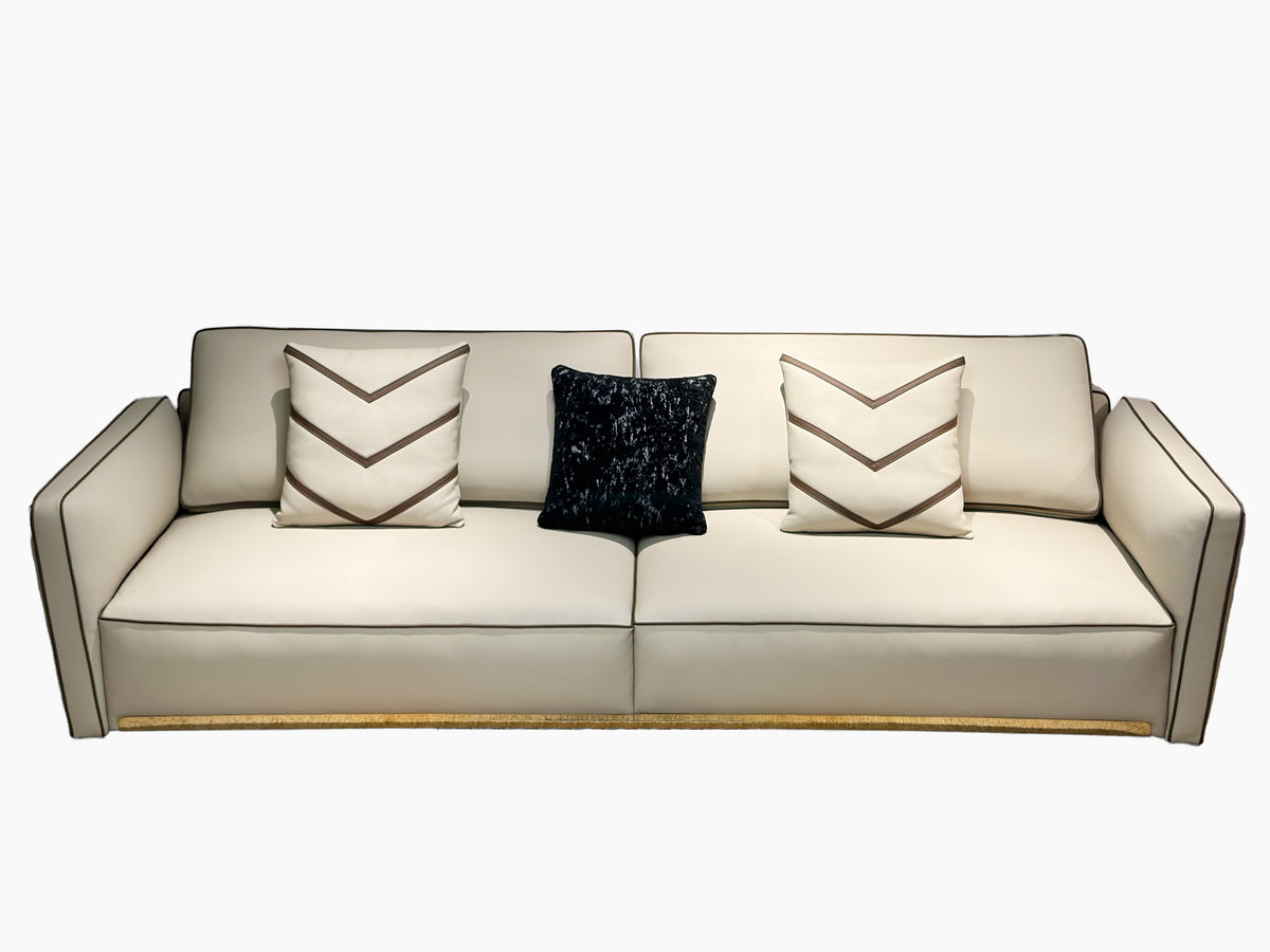 Luxury Cream Leather Sofa with Decorative Pillows and Gold Accents