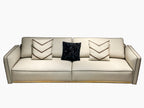 Luxury Cream Leather Sofa with Decorative Pillows and Gold Accents