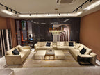 Luxury Cream Leather Sofa with Decorative Pillows and Gold Accents
