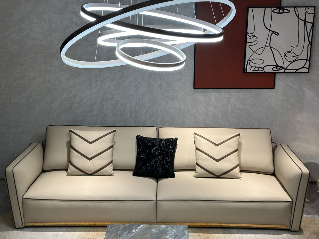Luxury Cream Leather Sofa with Decorative Pillows and Gold Accents