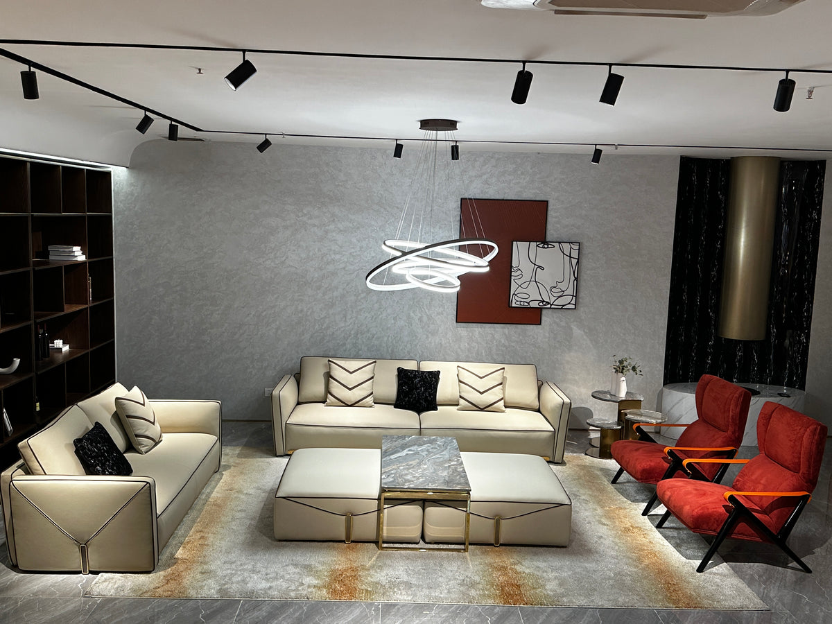 Luxury Cream Leather Sofa with Decorative Pillows and Gold Accents