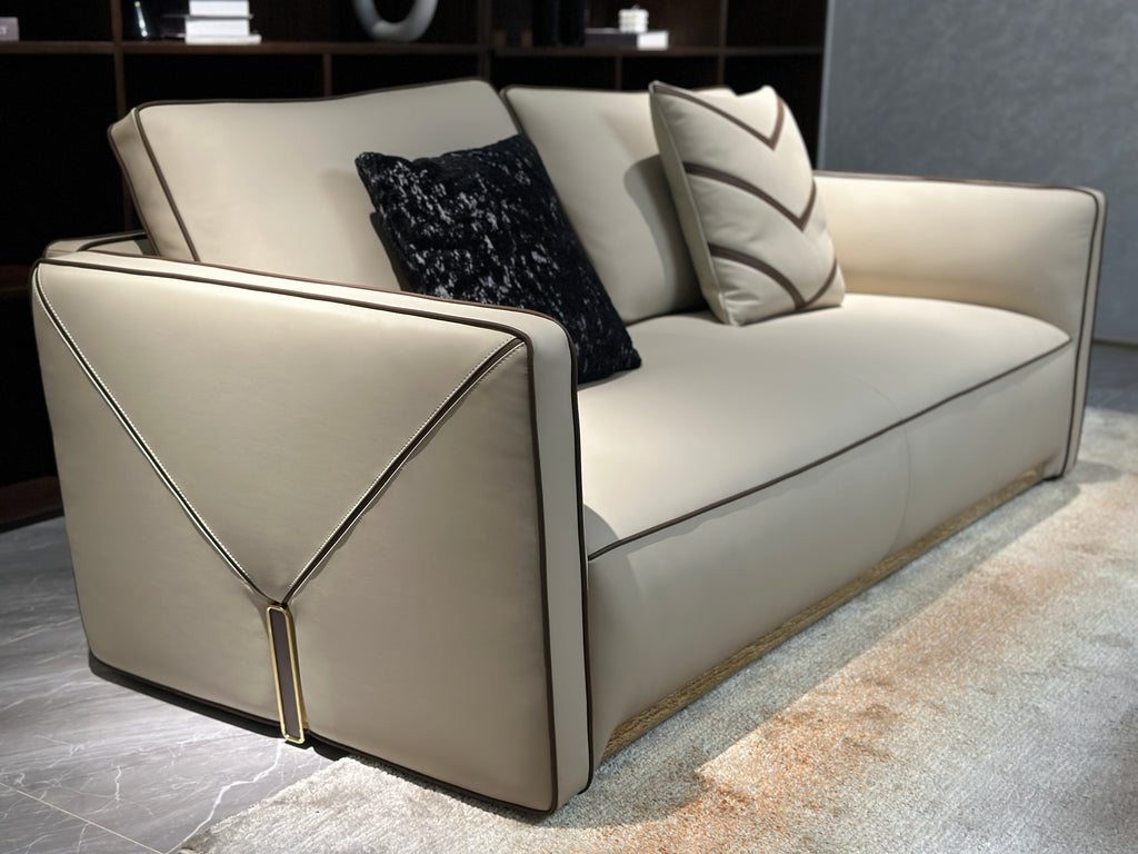 Luxury Cream Leather Sofa with Decorative Pillows and Gold Accents