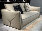 Luxury Cream Leather Sofa with Decorative Pillows and Gold Accents